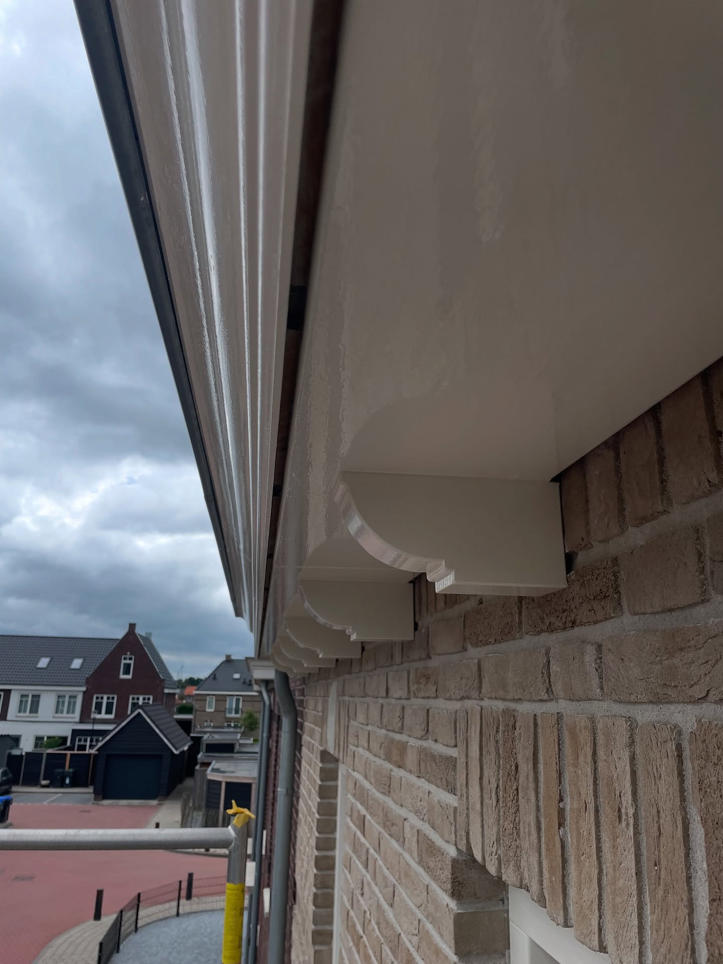 Pas geschilderde witte boeidelen en overstek tegen een bewolkte lucht